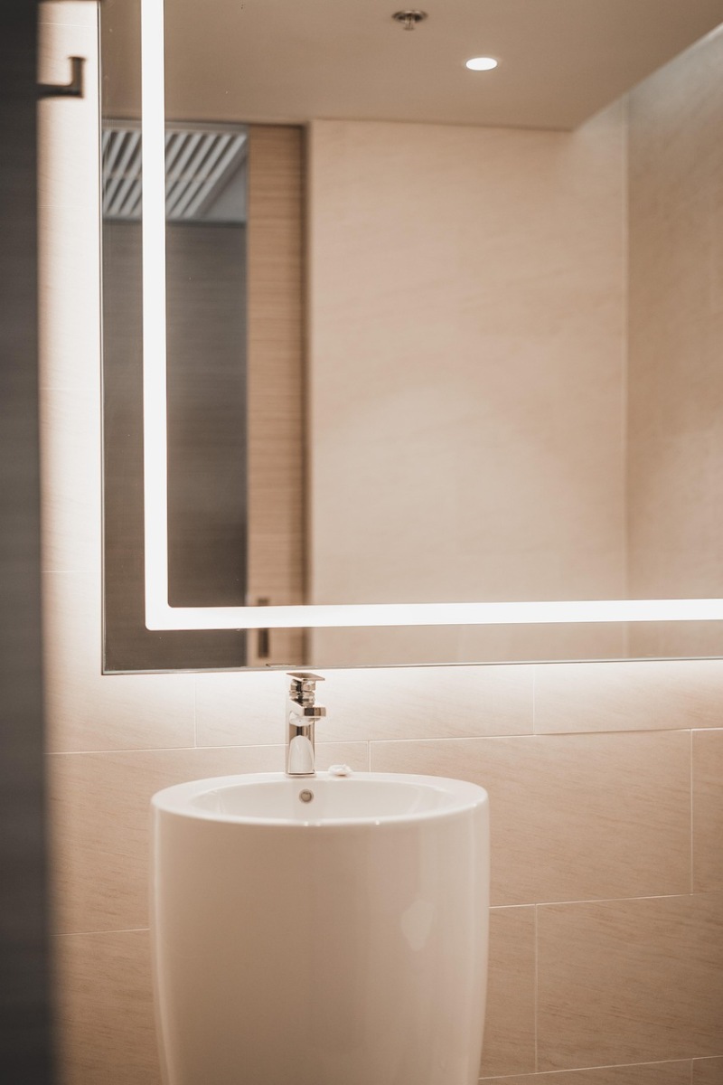 Contemporary bathroom lighting fixture mounted above a mirror.