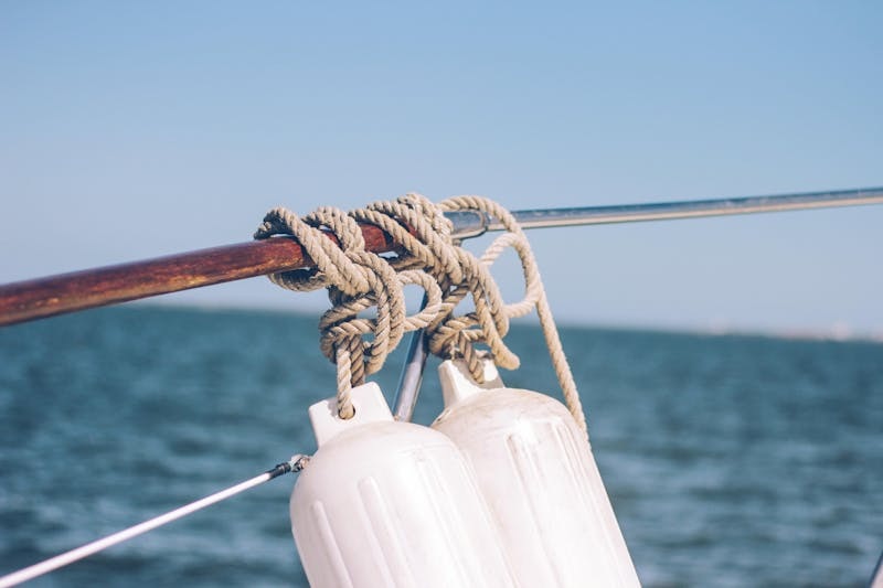 Close-up of a boat fender hanging on the side of a docked vessel.
