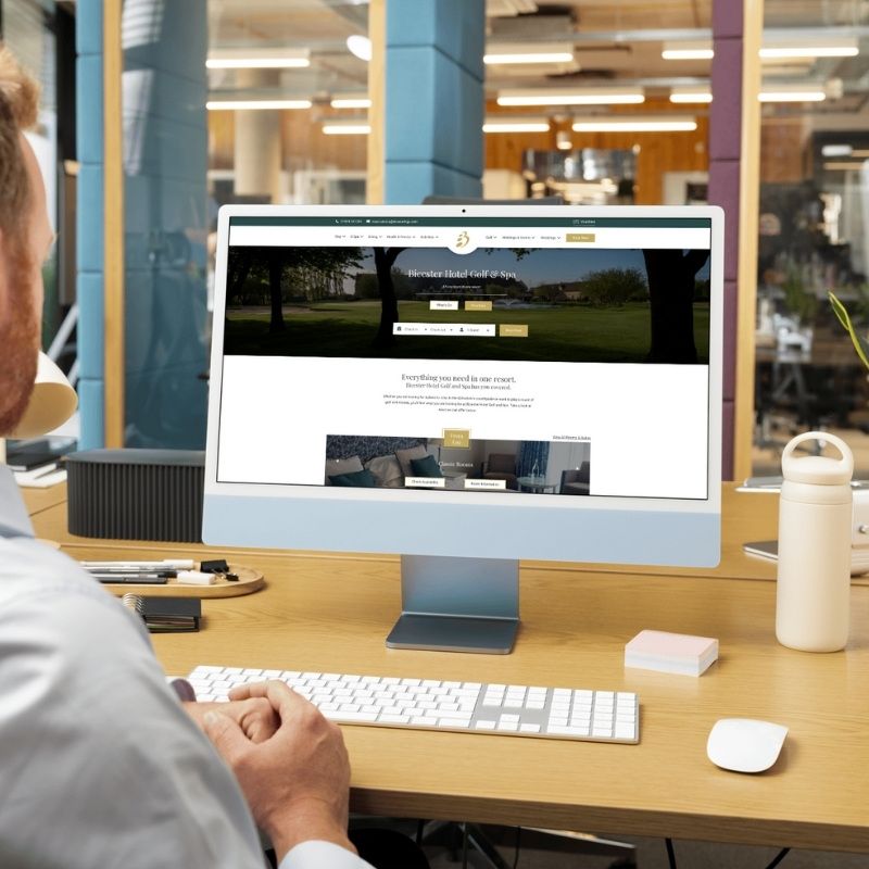 Computer screen mockup presenting the Bicester Hotel Golf & Spa website layout.