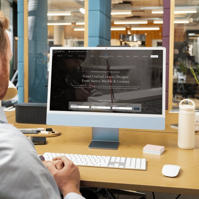 Computer screen mockup showing the Surrey Marble & Granite website design.