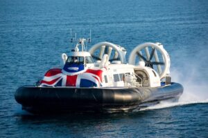 Passenger hovercraft travelling across the water on a sunny day.