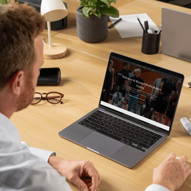 Laptop mockup showcasing the Bicester Gym website homepage.