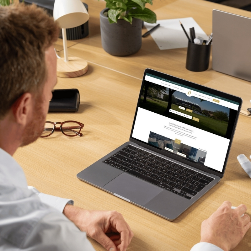Laptop mockup showcasing the Bicester Hotel Golf & Spa website homepage.
