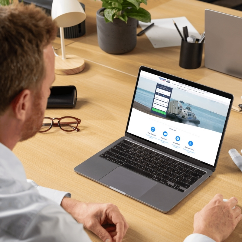 Laptop mockup showcasing the Hovertravel website homepage.