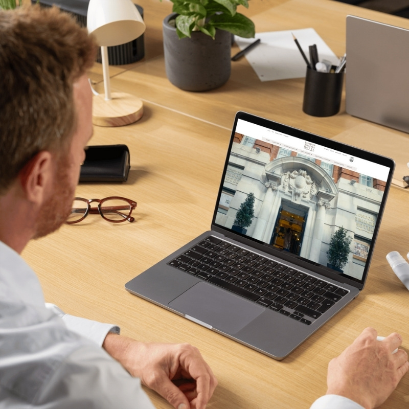 Laptop mockup showcasing the London Bridge Hotel website homepage.