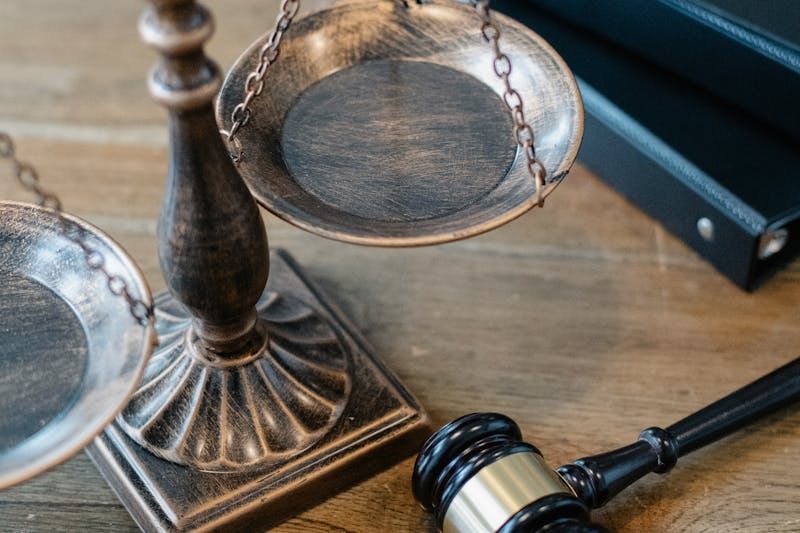 Close-up of a lawyer’s hand holding a briefcase handle.