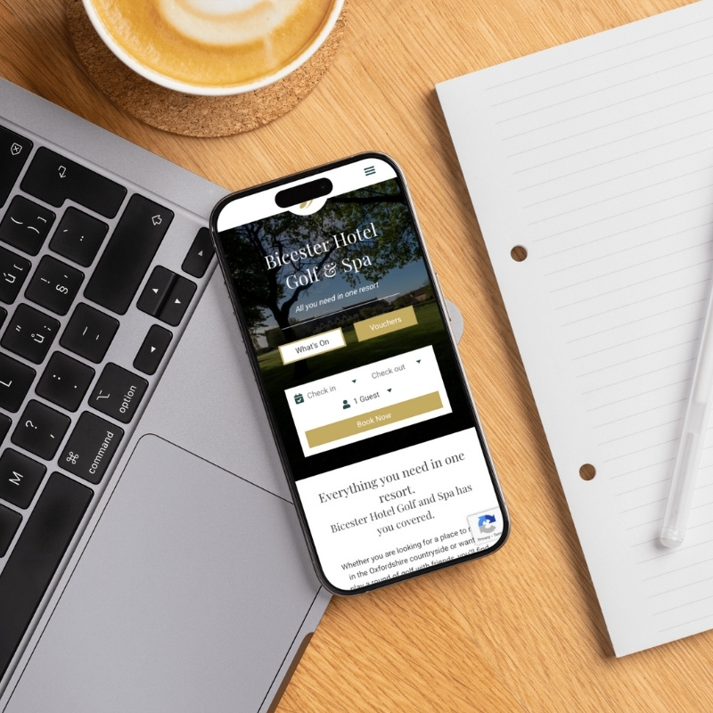 Smartphone screen mockup showing the Bicester Hotel Golf & Spa website design.