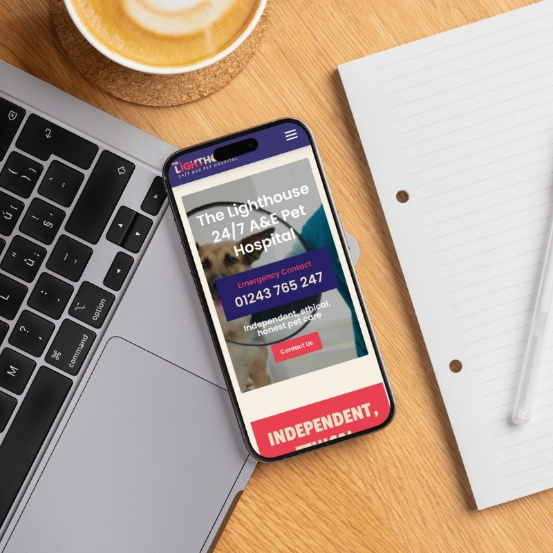 Smartphone screen mockup displaying The Lighthouse Vets responsive website layout.
