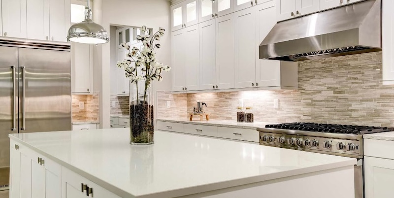 Modern bathroom with white marble surfaces and a sleek minimalist design.